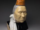 a close up of a statue of a person wearing a hat