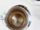 a silver coffee pot sitting on a table next to a blender