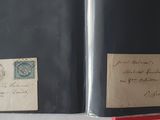 two old envelopes with stamps on them sitting on a table