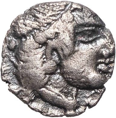a silver coin with a face of a man and a woman