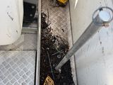 a picture of a truck that has a bunch of trash in it
