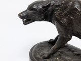 bronze statue of a dog on a marble base on a white background