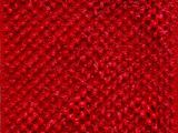 a close up of a red rug on a wooden floor