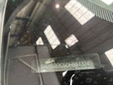 a close up of a car ' s rear view mirror with a sticker on it