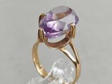 a close up of a ring with an amethorate stone in it