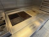 a large stainless steel stove in the middle of a kitchen
