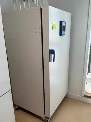 a white refrigerator in the corner of a room