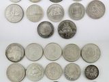 a pile of silver coins sitting on top of a white surface