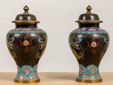 two vases that are sitting on a table