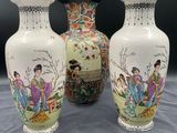 three vases with asian designs on them on a table