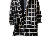 an image of a black and white checkered coat on a hanger