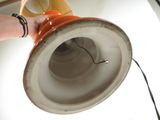 a person holding a lamp that is on a table