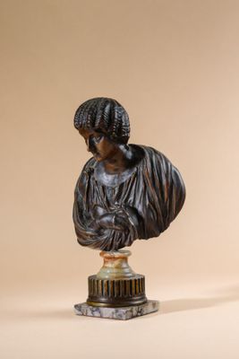 a statue of a woman on a pedestal next to a vase