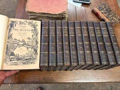 de nombreux livres posés sur une table, avec une calculatrice et une autre calculatrice