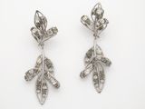 a pair of diamond and silver earrings