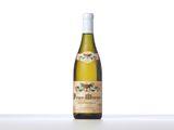 a bottle of white wine sitting on top of a table