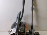 a vacuum that is sitting on a table next to a cord