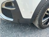 a close up of a car ' s front bumper and tire
