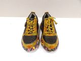 pair of yellow and black running shoes with yellow laces on them