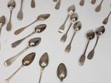 a lot of silver spoons and spoon spoons on the table