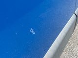 a close up of a blue car with the door open
