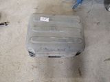 a piece of luggage sitting on the floor in the garage