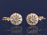a pair of gold and diamond flower earrings