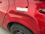 a red car that has a sticker on the side of it