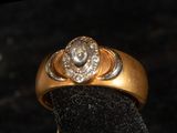 a gold ring with a diamond on top of it