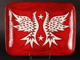 an image of a red plate with a white bird on it