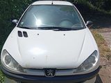 a white car that is parked on the side of the road