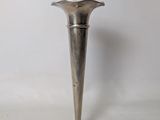 a silver vase that is sitting on a table