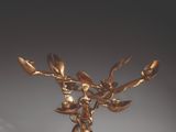 a close up of a gold sculpture of a tree on a table