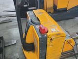 a yellow forklift with a gas pump in the back