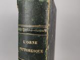 an old book sitting on top of a white table
