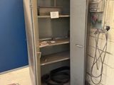 a metal cabinet with a door open in a room