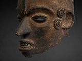 an image of a close up of a wooden mask on a black background