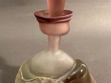 a glass perfume bottle with a glass stopper on it