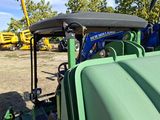 a tractor that is parked in a lot with other tractors