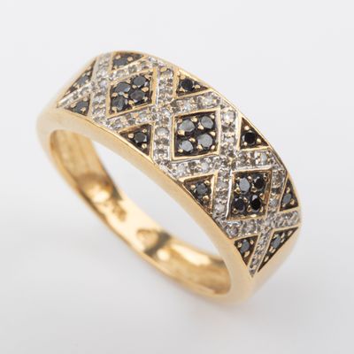 a yellow gold ring with black and white diamonds