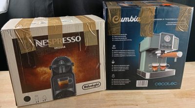 two boxes of coffee machines sitting on a table