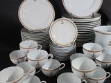 many cups and saucers sitting on a black table