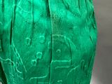 a close up of a green pants with writing on it