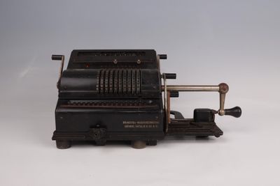an old typewriter machine sitting on top of a white surface