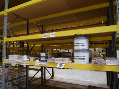 a yellow shelf in the middle of a warehouse filled with boxes