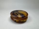 a picture of a brown and black object on a white surface