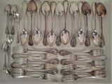 a lot of silver spoons and forks in a white box