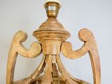 a wooden chandelier with a clock on the top of it