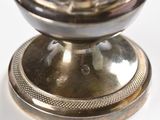 a silver plate with a clock on top of it