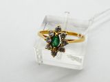 an image of a gold ring with a green stone surrounded by white diamonds
